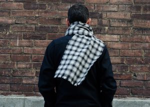 Checked scarf wrapped around the neck of a man