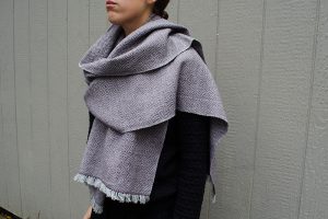 Handwoven scarf wrapped around woman